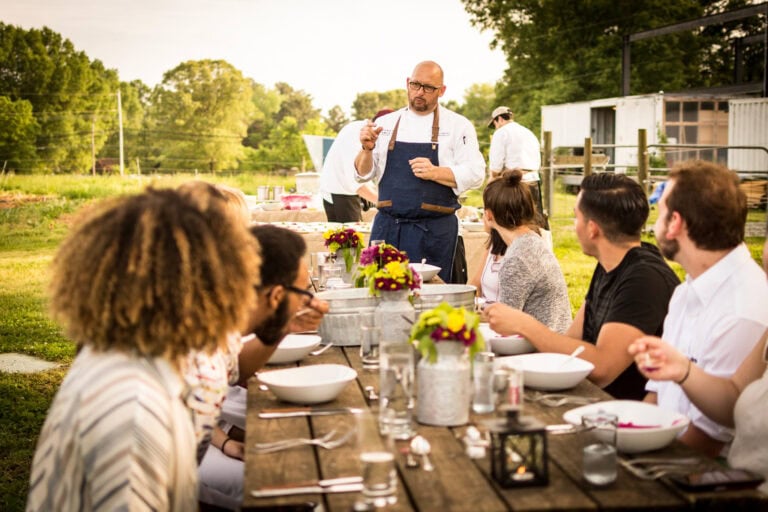 Chef speaking to guests at table
