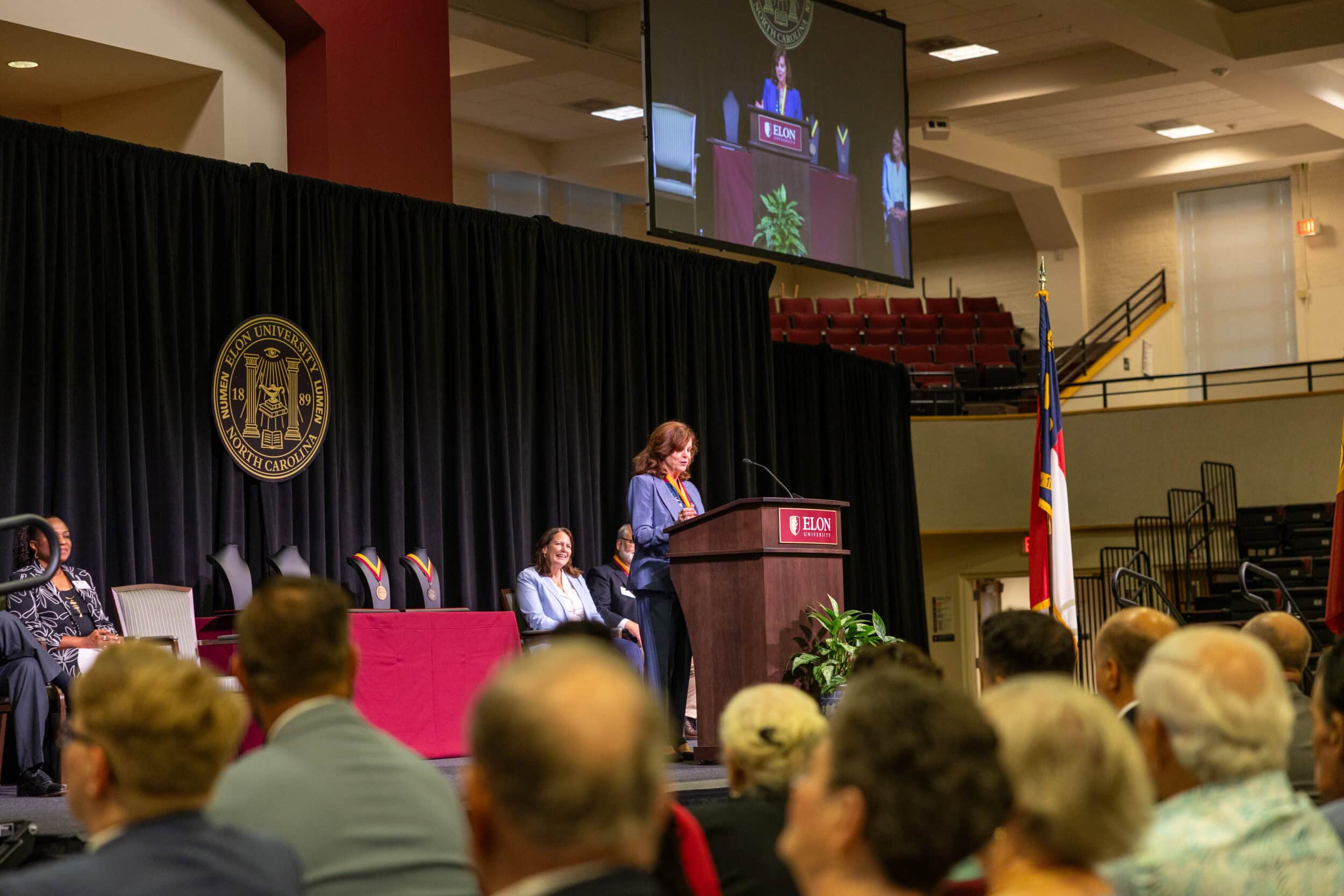 Mary Thornton speaks at a podium